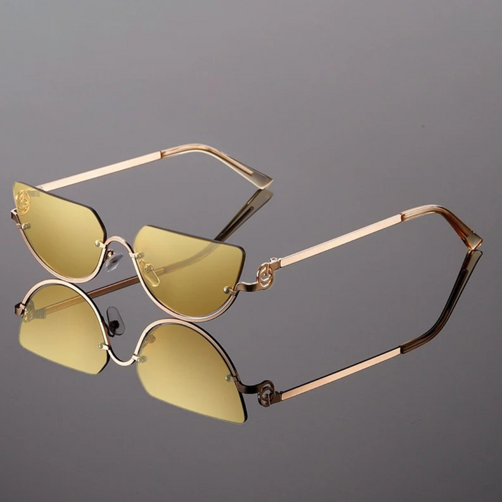 Eleve seu estilo com os Óculos de Sol Lírio Proteção UV-400, um acessório que une sofisticação e segurança para os seus olhos. Com design minimalista e armação leve, este modelo inspirado no luxo retrô destaca-se pelo charme e modernidade. As lentes de alta qualidade garantem proteção UV-400, bloqueando os raios nocivos do sol e proporcionando conforto visual inigualável. 