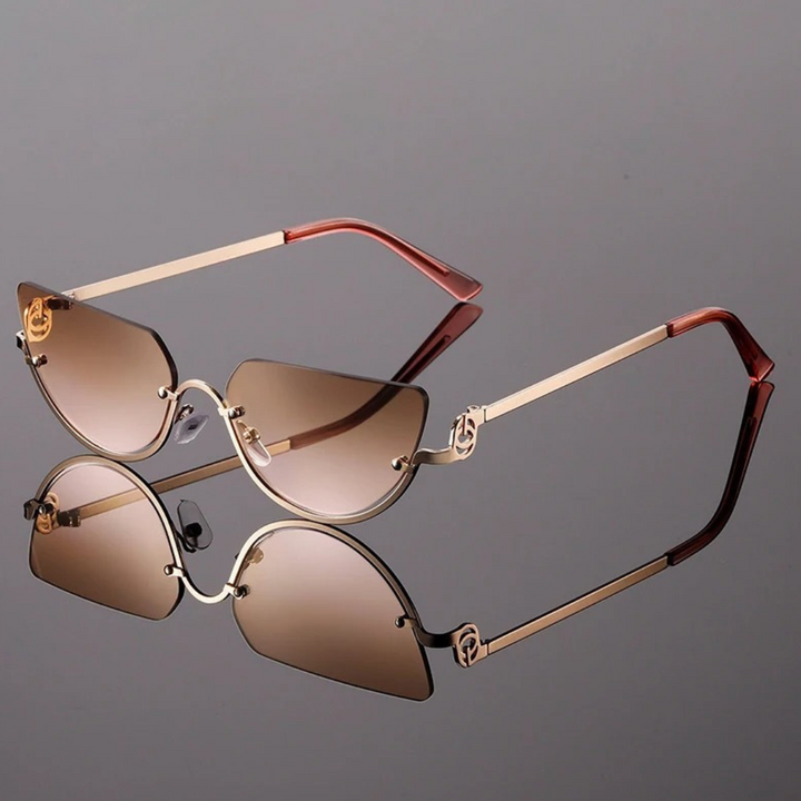 Eleve seu estilo com os Óculos de Sol Lírio Proteção UV-400, um acessório que une sofisticação e segurança para os seus olhos. Com design minimalista e armação leve, este modelo inspirado no luxo retrô destaca-se pelo charme e modernidade. As lentes de alta qualidade garantem proteção UV-400, bloqueando os raios nocivos do sol e proporcionando conforto visual inigualável. 